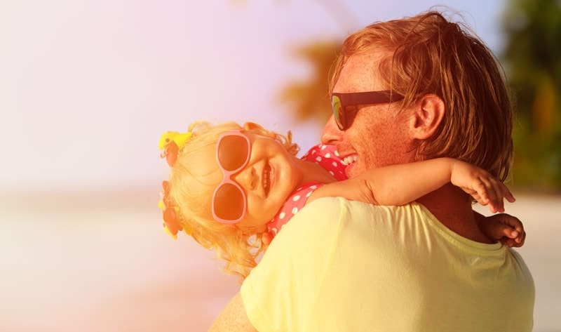 little-girl-on-beach-with-dad-happy