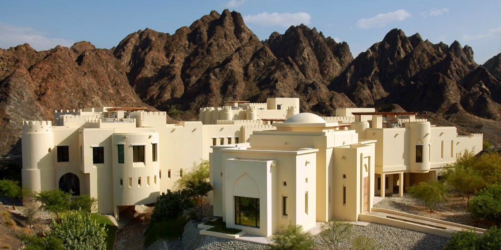 al-bustan-hotel-traditional-arabian-buildings-against-mountains-visit-muscat-oman