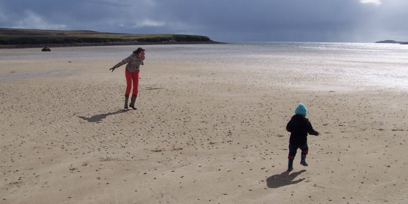 Mother and son playing on beach Isle of Lewis