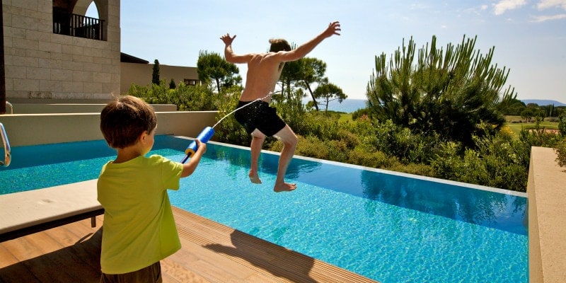 Simon Reeve and son by the pool
