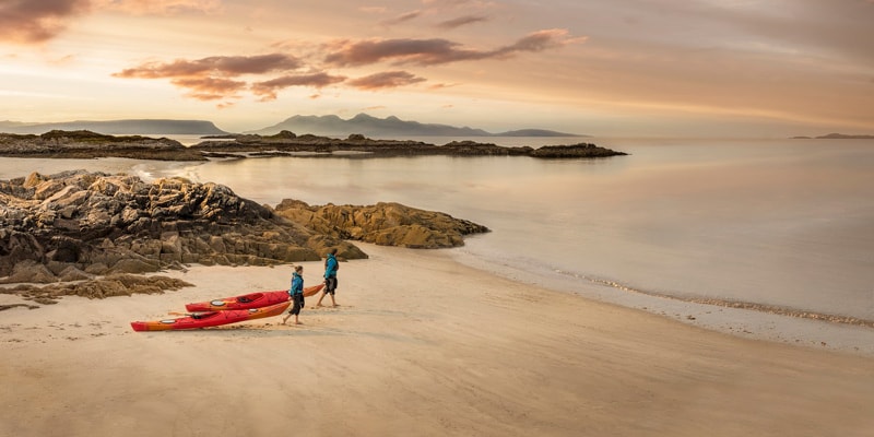 people with canoes in scotland