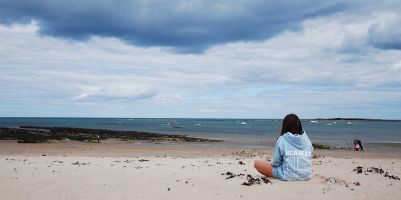 girl looks out to sea at newton-by-the-sea