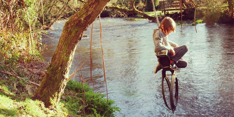 fin-on-rope-swing-over-river-in-devon