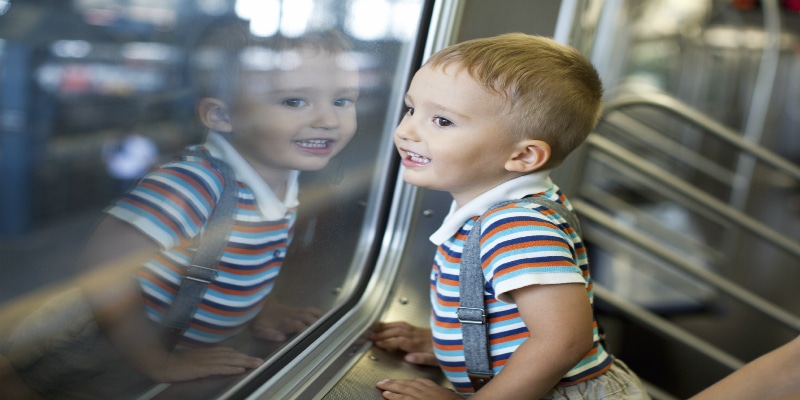 Young happy boy on train