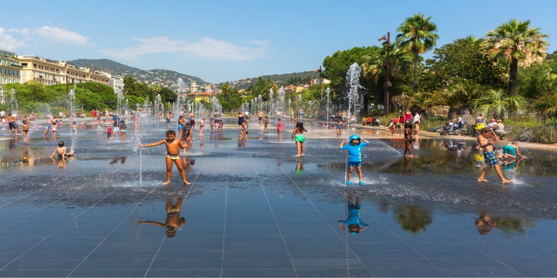 children enjoying fountain france