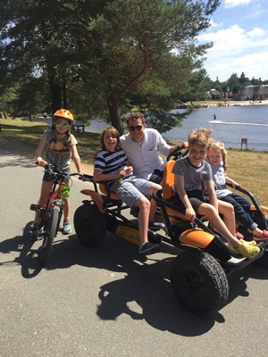 three children and a dad on a Rosaline cycle buggie in the Loire