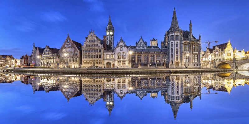 Ghent skyline reflecting in water in the evening, Flanders, Belgium