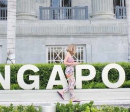 Singapore sign with girl infront