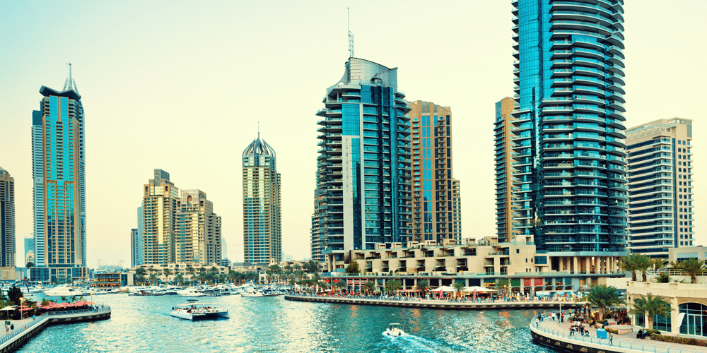 Dubai marina with yachts, luxury apartments and restaurants
