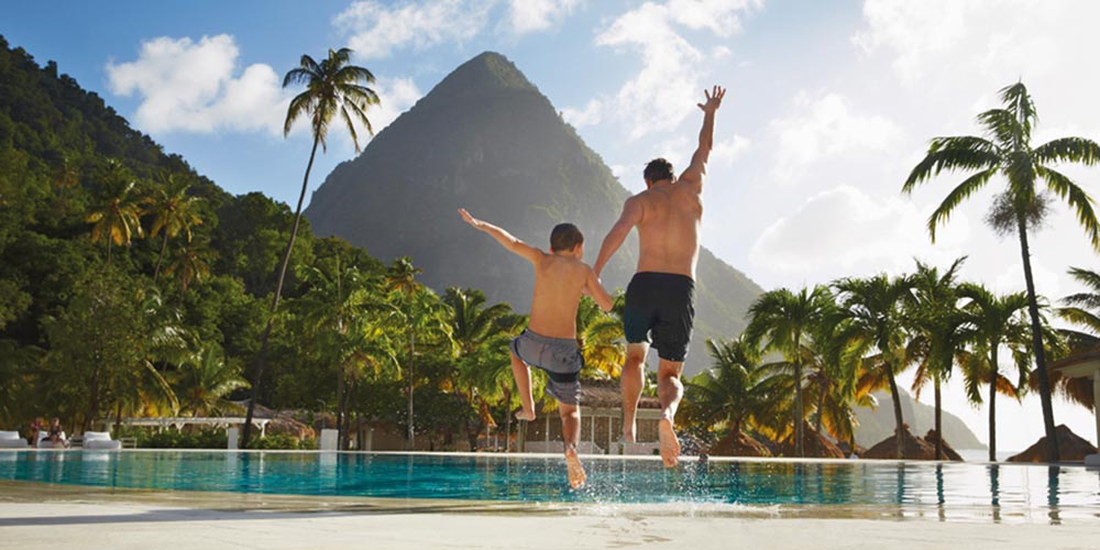 Man and boy jumping into pool Saint Lucia Caribtours