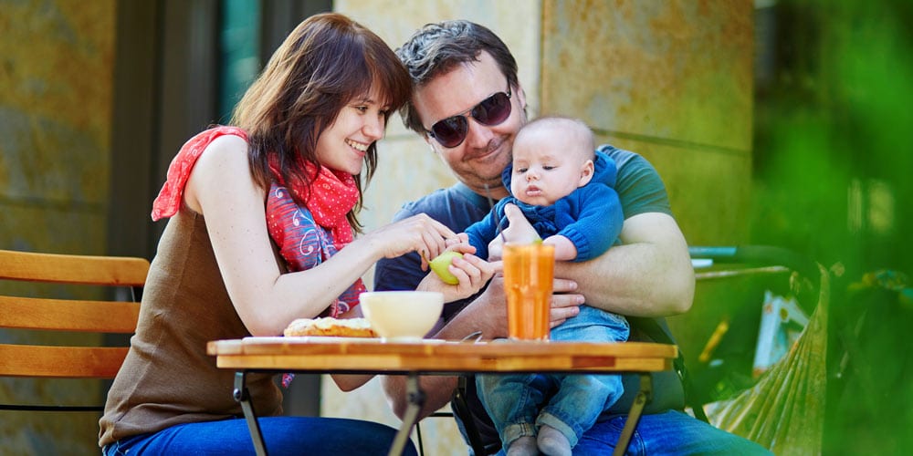 family having breakfast - tips for your first holiday with a baby