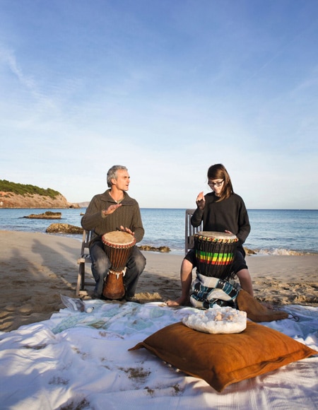 Man and woman drumming on beach off-season ibiza