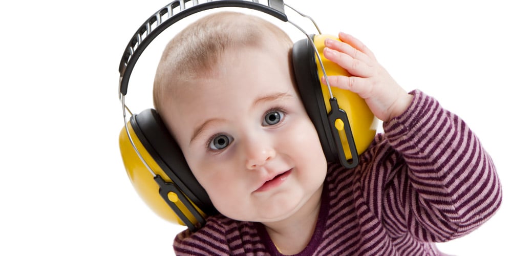 baby with ear defenders - tips for your first holiday with a baby