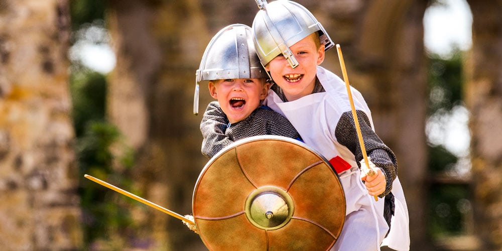 boys in roman costume - things to do in June