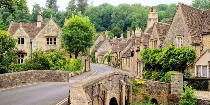The cotswolds England village street with historic houses family holiday destinations 2022