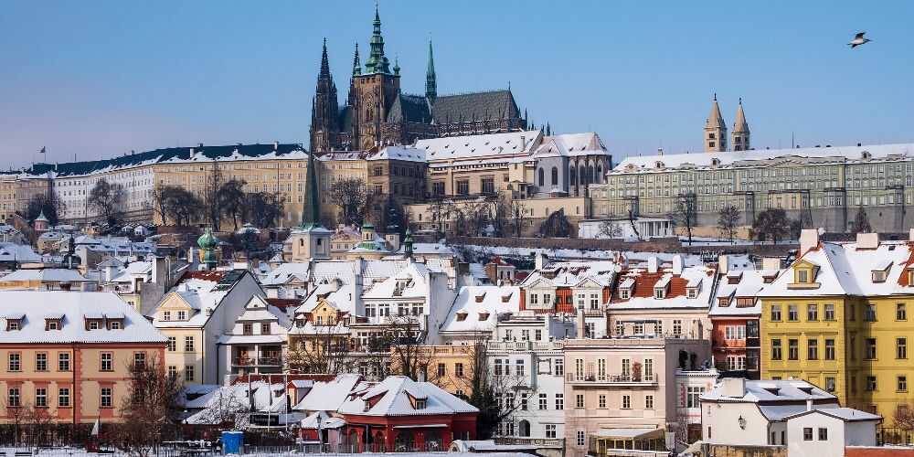 Prague winter city breaks snowy rooftops seen from the Charles Bridge