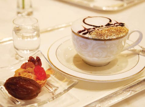 Gold-leafed topped cappuccino and dried fruit at the Emirates Palace