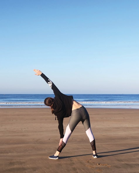 Yoga poses on Paradis Plage beach, Morocco