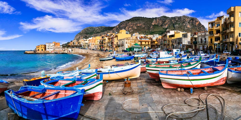 harbour-with-colourful-boats-and-waterfront-houses-sicily