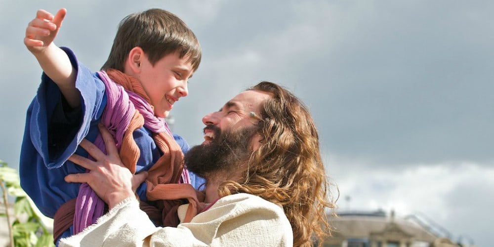 Easter holiday activities for the family, Jesus lifting boy, The Passion of Jesus Easter performance