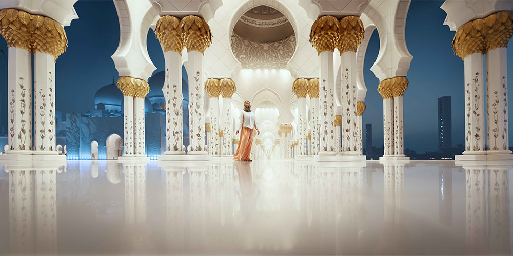 woman-wandering-through-sheik-zayed-grand-mosque-holidays-to-abu-dhabi