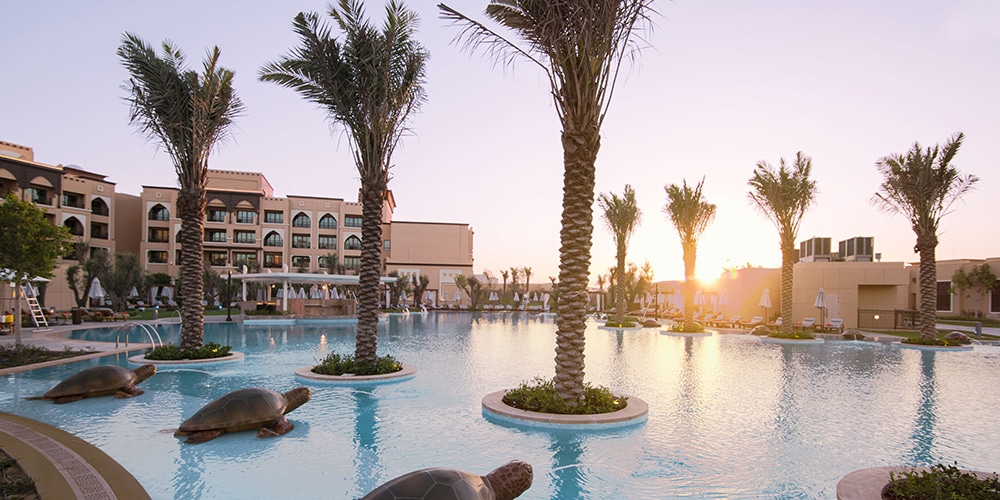saadiyat-rotana-resort-and-villas-swimming-pool-with-palm-trees-uae