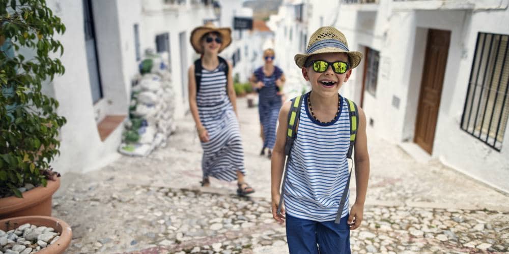 best family holiday destinations for 2019, boy walking up cobbled street in Andulucia, Spain