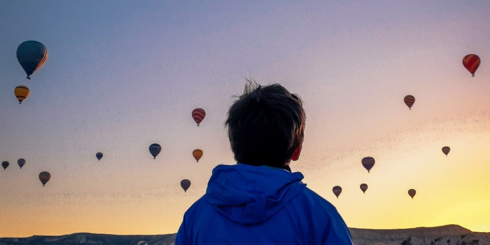best family holiday destinations for 2019, boy watching balloons in Cappadocia, Turkey
