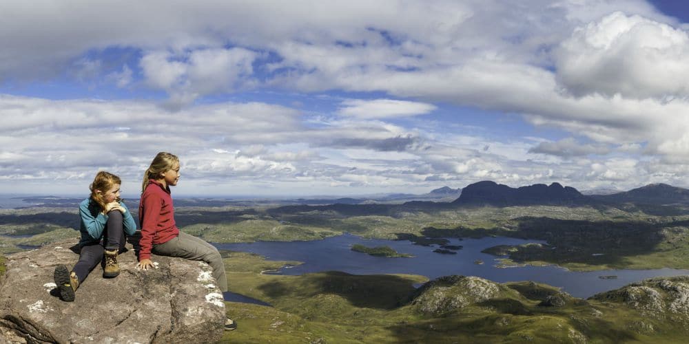 Best family holiday destinations 2019, girls look out over Scottish Highlands