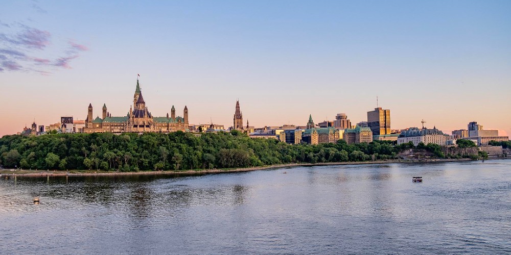 parliament-buildings-at-sunset-seen-from-across-the-river-family-holidays-in-ottawa-2022