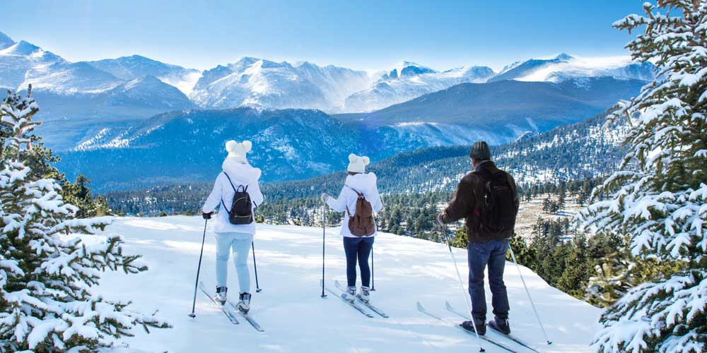skiers-looking-over-rocky-mountains-colorado