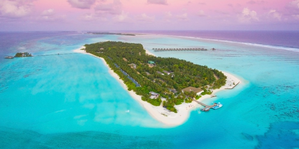 aerial-shot-villa-hotels-sun-island-resort-maldives-under-purple-sky 