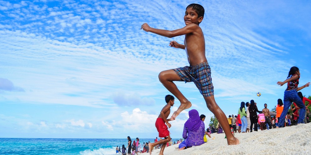 boy-jumping-on-beach-indian-ocean