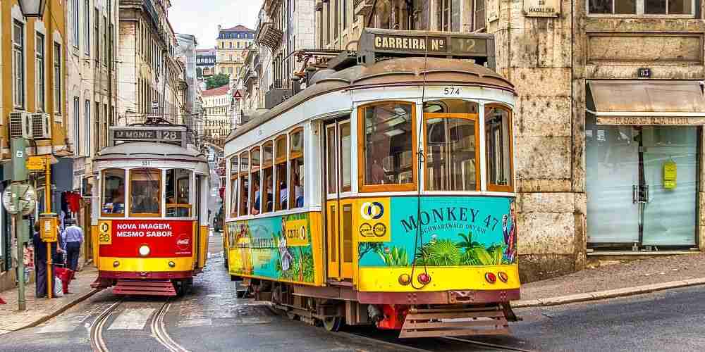 classic-lisbon-trams-driving-through-the-historic-district-narrow-streets-2022
