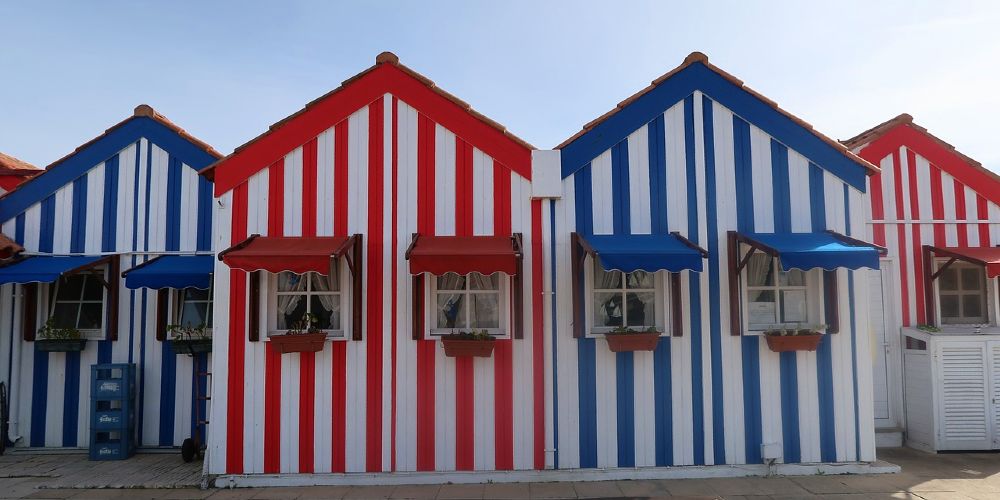 stripy-beach-houses-on-the-seafront-at-costa-nova-da-prado-portugal-2022