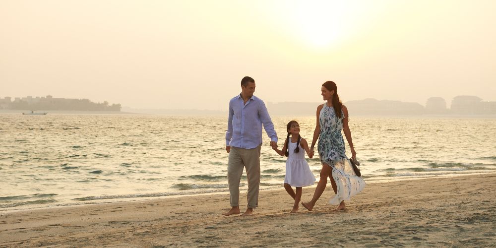 family-walking-sunset-beach-dubai