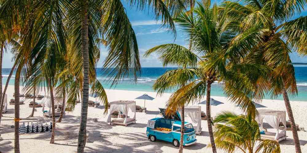 Blue volkswagon food truck on tropical Baa Atoll beach Maldives