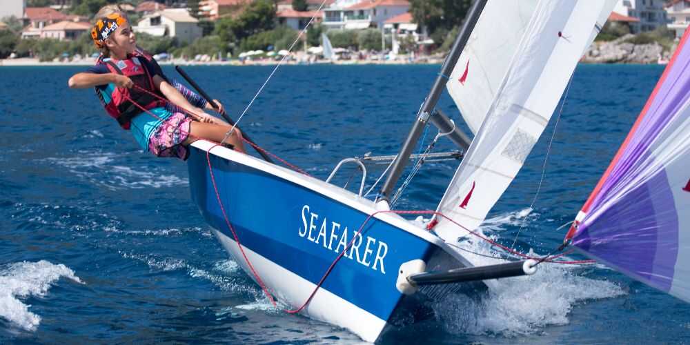 family sailing holidays at Nikiana Beach Club young girl sailing solo on Ionian Sea on Lefkada Island