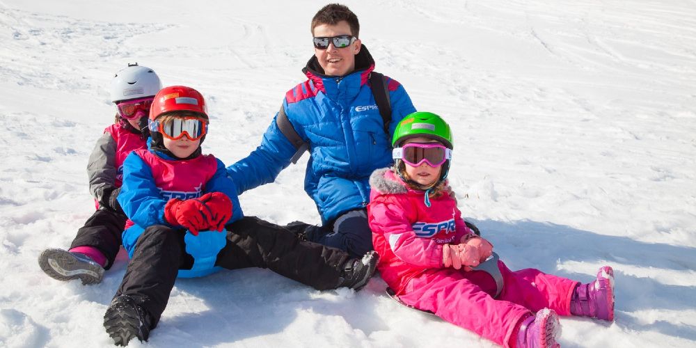 Esprit Ski childcare staff with young kids on ski slopes winter 2021
