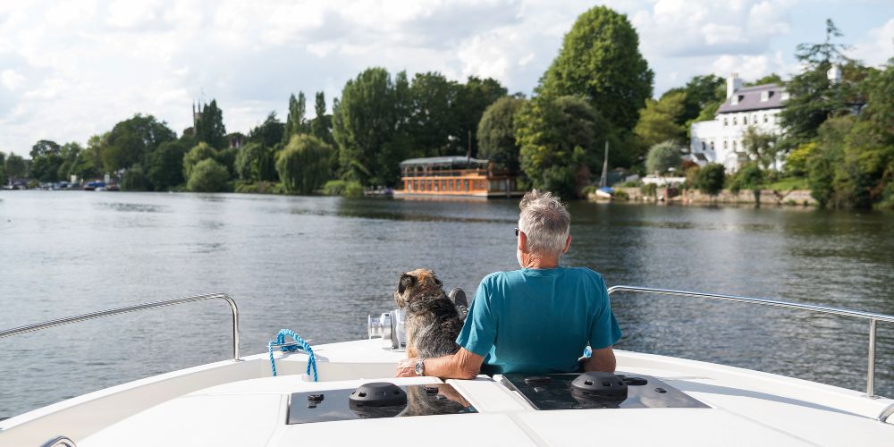 Man relaxing on deck of boat on the River Thames at Henley on Thames 