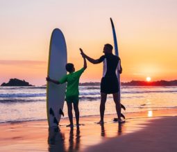 father-and-son-on-beach-with-surfboards-at-sunset-southern-sri-lanka-surfing-holidays