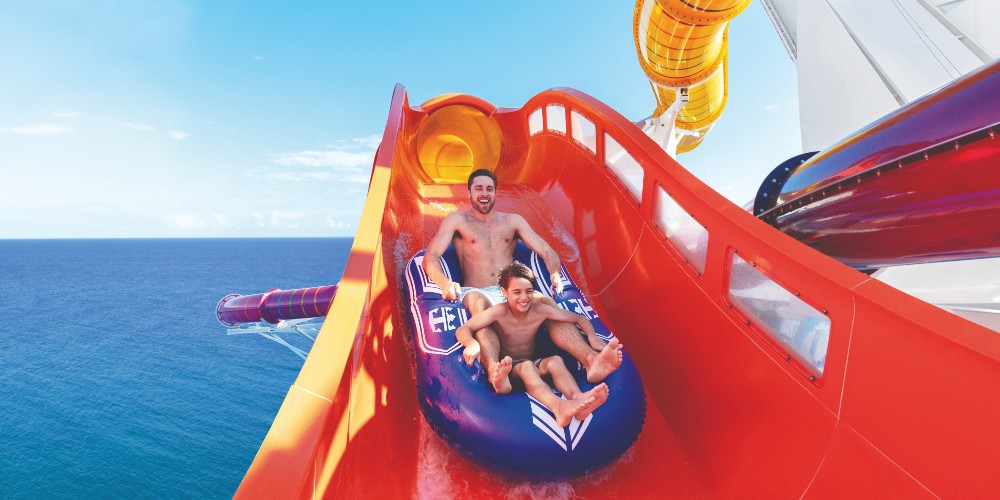 father-son-on-blaster-waterslide-aboard-royal-caribbean-best-family-cruise-holidays