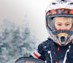 little-boy-snowmobile-helmet-snowy-winter-landscape-kid-friendly-whistler-canada