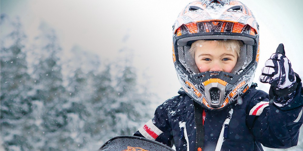 little-boy-snowmobile-helmet-snowy-winter-landscape-kid-friendly-whistler-canada