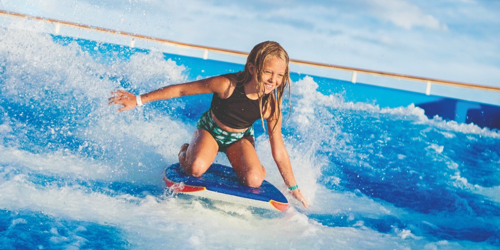 little-girl-on-surf-flow-rider-on-board-ship-best-family-cruise-holidays-royal-caribbean-2022