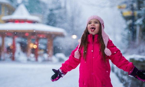 whistler-village-little-girl-in-ski-gear-tasting-snow-start-of-a-family-ski-day