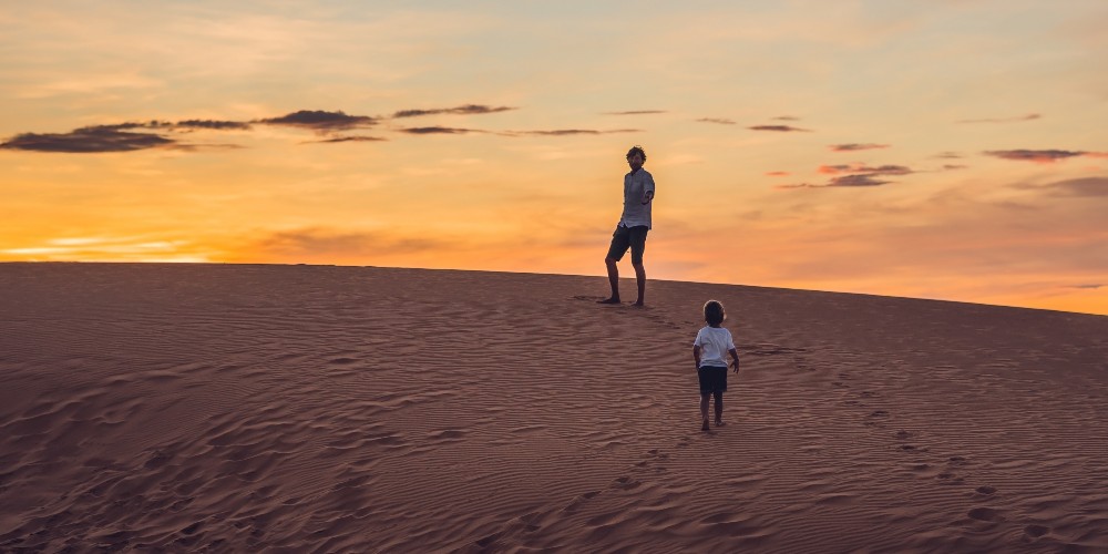 young-boy-father-sand-dune-hiking-sunset-oman-desert-original-travel-family-holidays