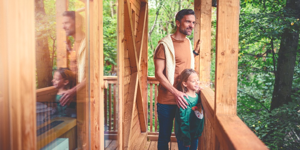 father-and-young-daughter-in-treehouse-the-garden-village-lake-bled-slovenia-family-eco-adventures