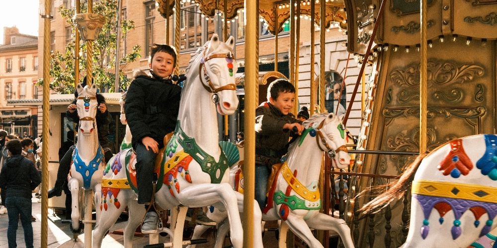 french-covid-rules-kids-on-carousel-le-capitol-toulouse-city-centre-france-dat-vo