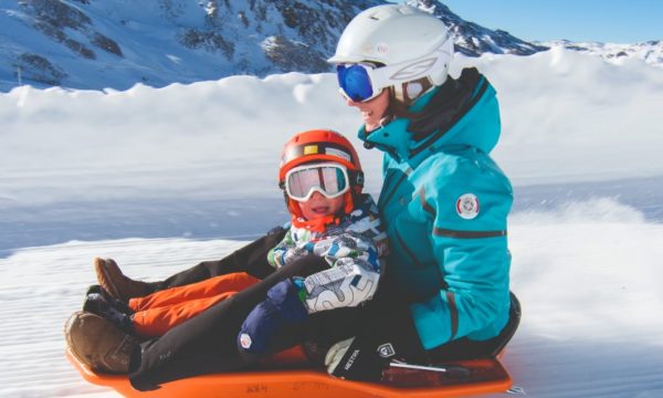 mother-and-toddler-tobogganing-luge-run-val-thorens-best-family-ski-resorts-winter-2022